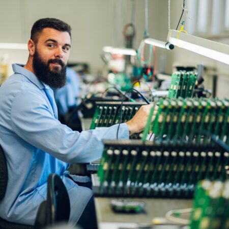 Electronics engineer working in a workshop with tin soldering parts